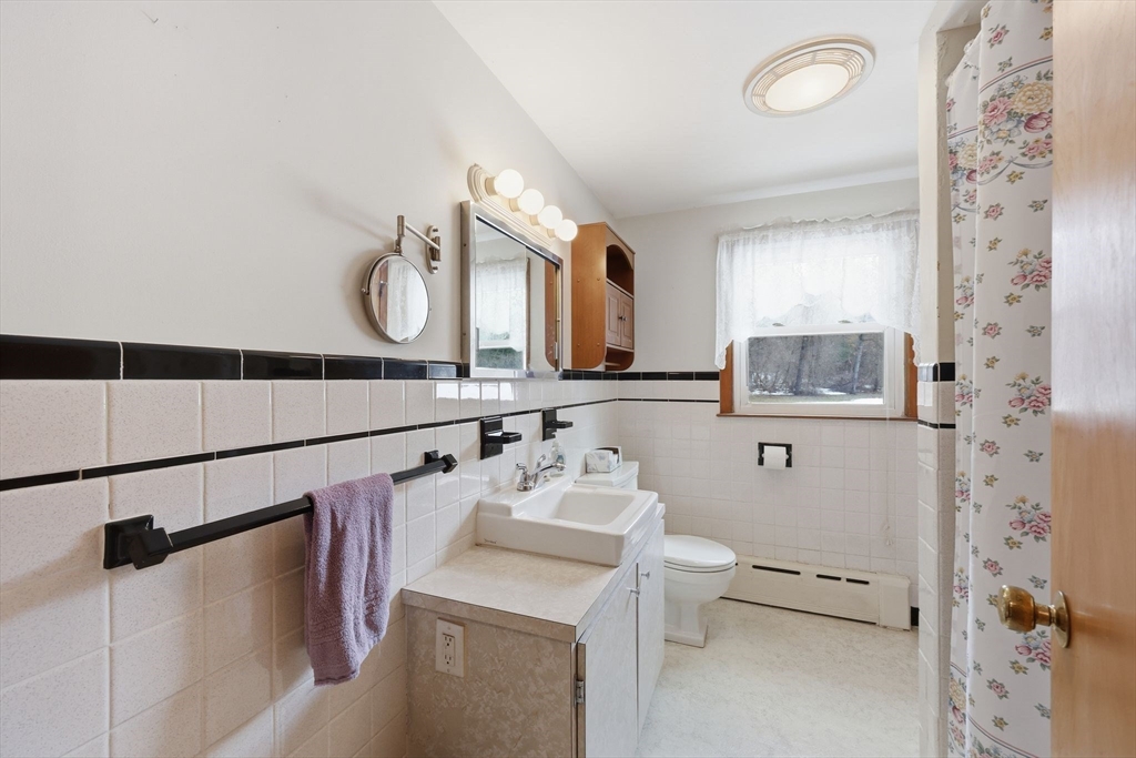 4452 High Street Palmer, MA 01069 - Photo 30 of 41 a bathroom with a sink vanity mirror and toilet