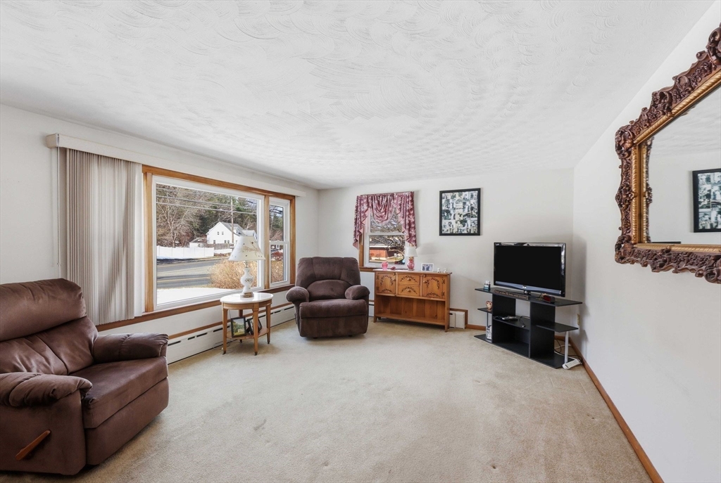 4452 High Street Palmer, MA 01069 - Photo 3 of 41 a living room with furniture and a flat screen tv