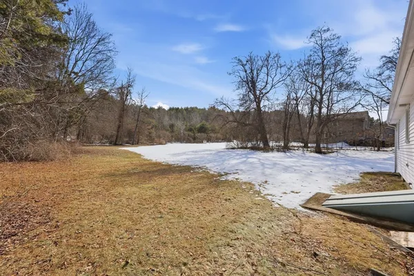 a view of yard covered with snow in front of house