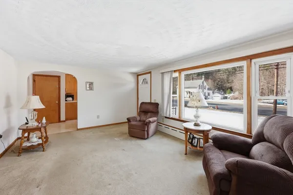 a living room with furniture and a large window