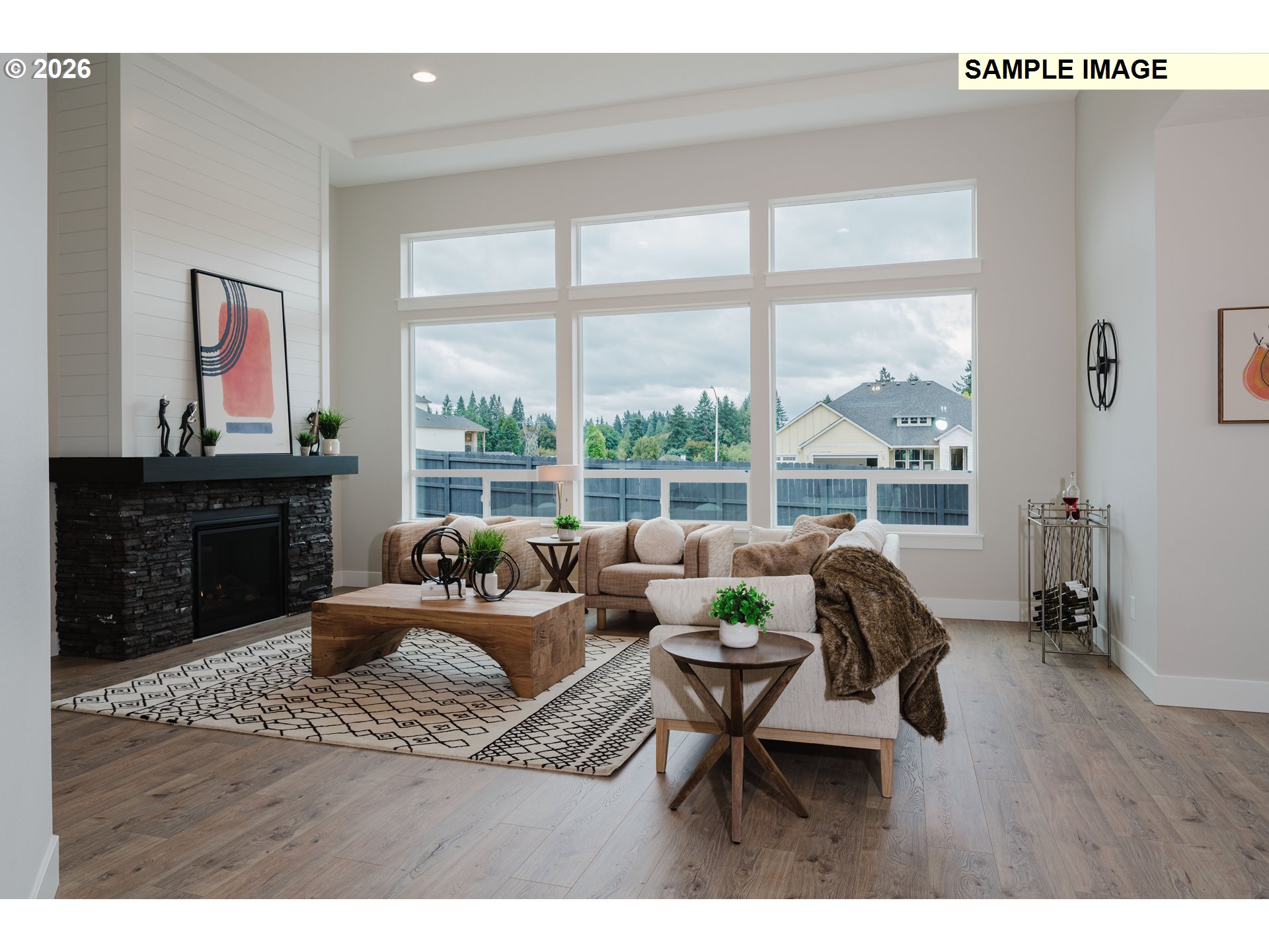 1403 North 41st Place Ridgefield, WA 98642 - Photo 5 of 30 a living room with furniture a fireplace and a floor to ceiling window