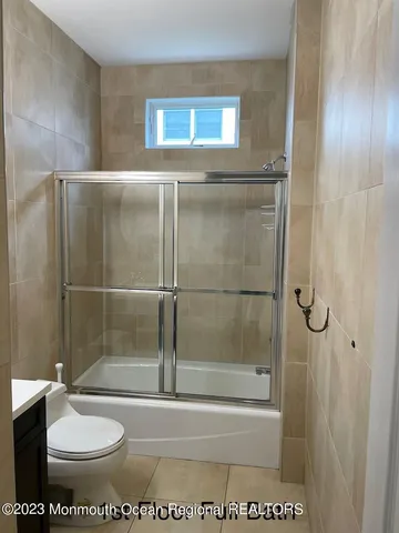 a bathroom with a shower a toilet and a sink