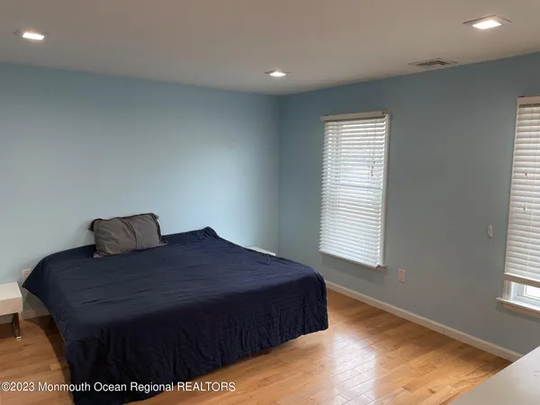 a large bed sitting in a bedroom next to a window