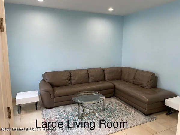 a living room with a couch and a sign