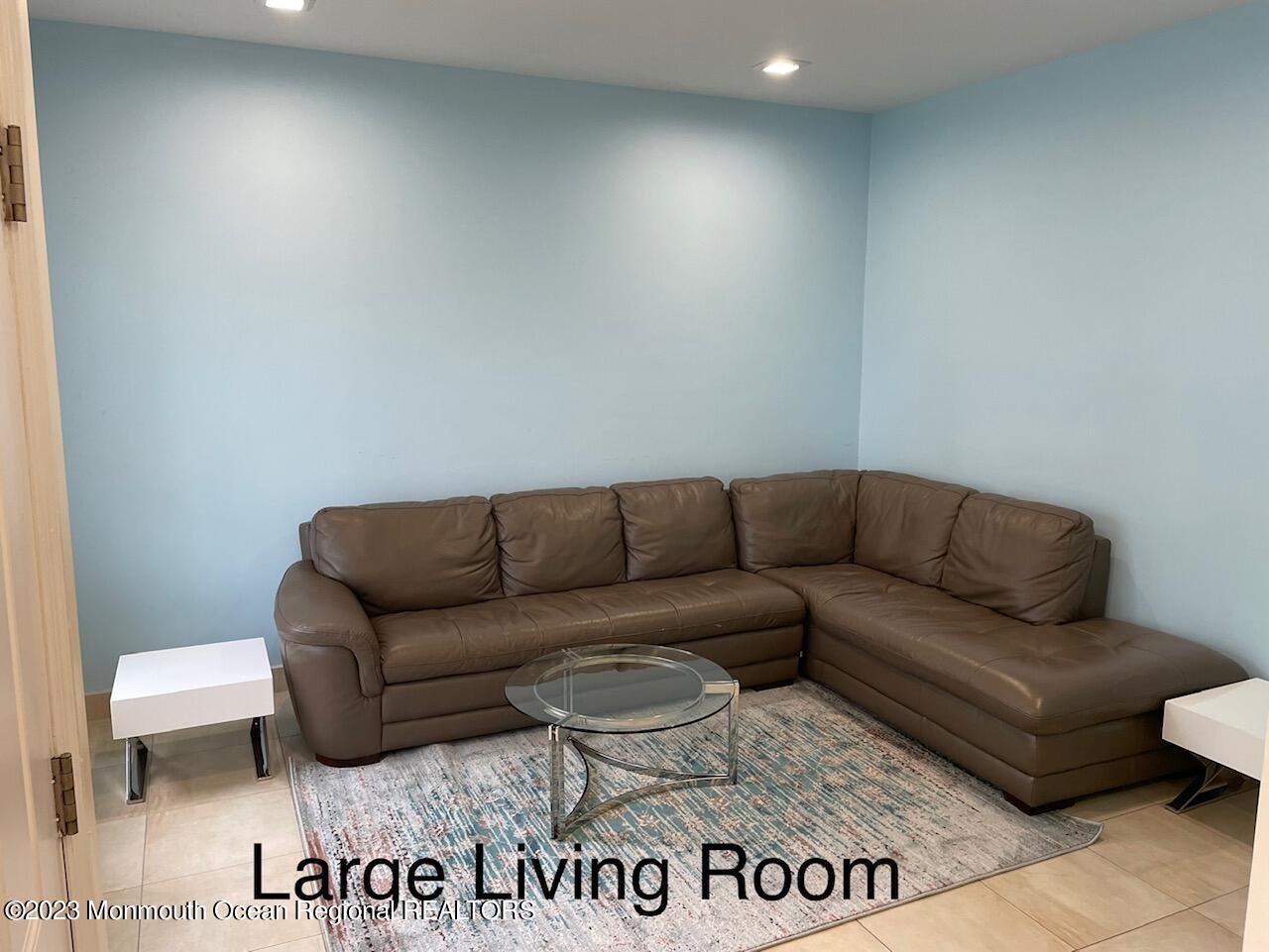 112 Poplar Avenue Deal, NJ 07723 - Photo 5 of 22 a living room with a couch and a sign