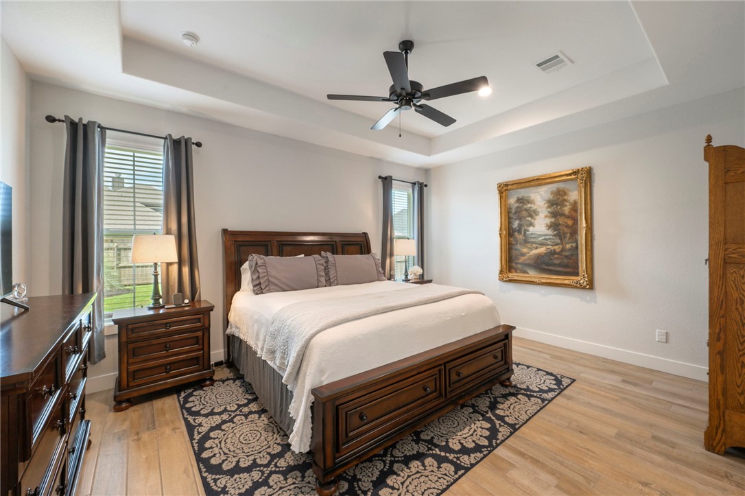 5019 Grayson Way Bryan, TX 77802 - Photo 10 of 26 Nice sized master bedroom with tray ceiling, newer wood look tile flooring and recessed lighting.