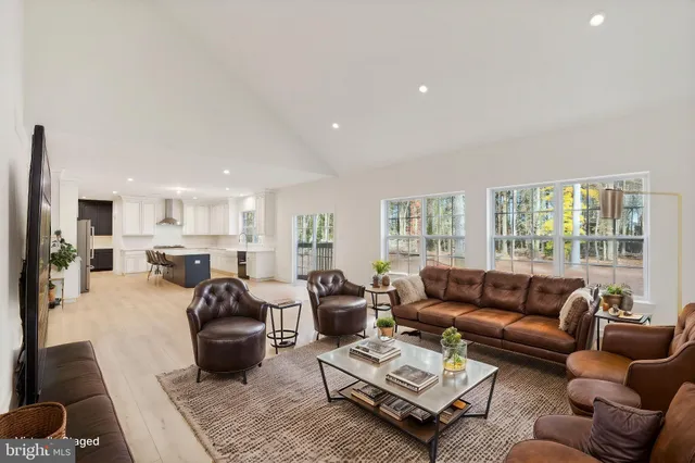 a living room with furniture fireplace and a large window