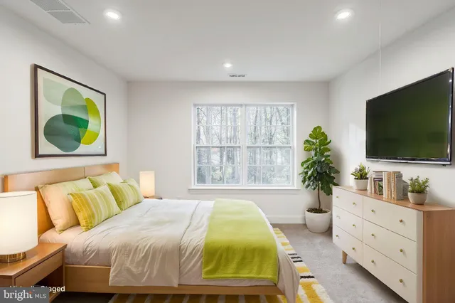 a bedroom with a bed and a flat screen television