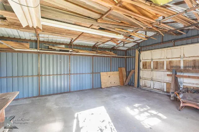 a view of a backyard with wooden walls