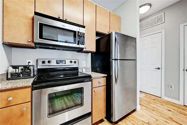 a kitchen with a stove microwave and refrigerator