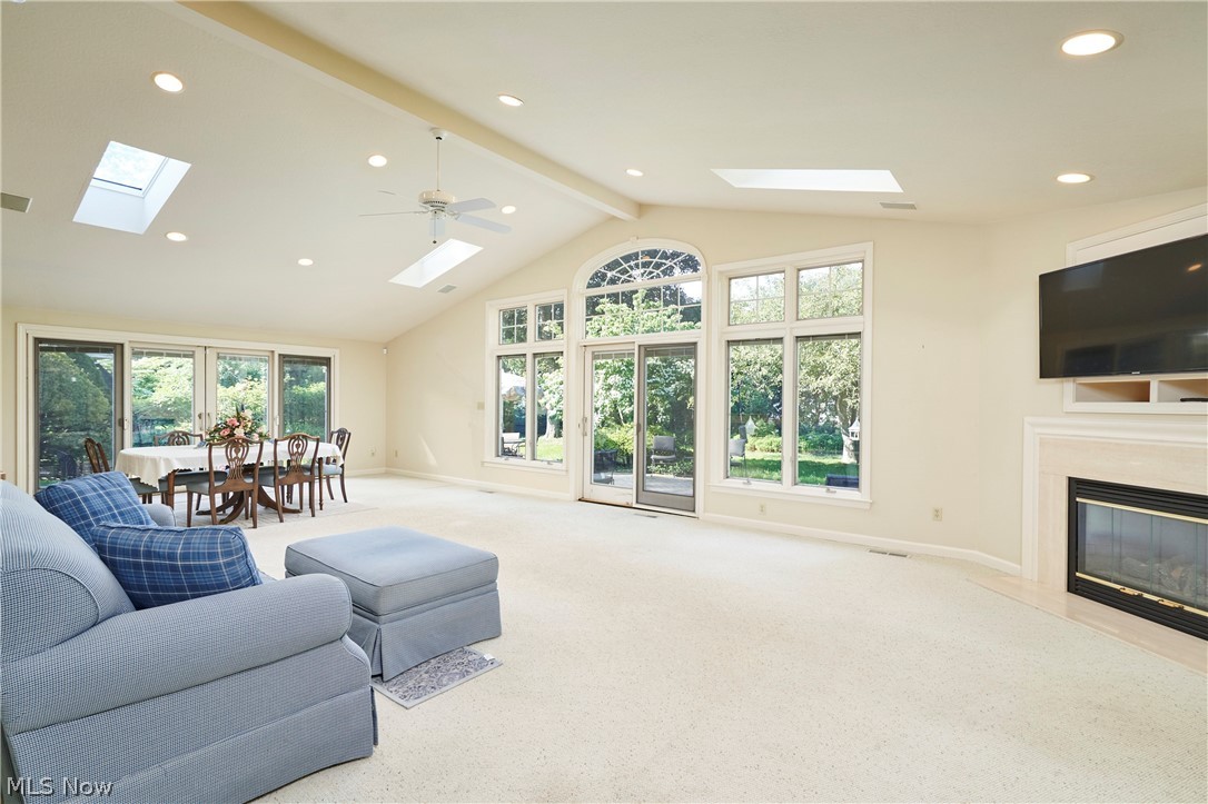 354 Tremont Road Akron, OH 44313 - Photo 6 of 34 Vaulted living space featuring an arch window, multiple skylights, and a ceiling fan