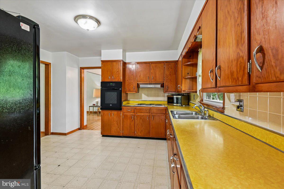 1509 Duvall Road Annapolis, MD 21409 - Photo 26 of 39 a view of a kitchen with kitchen island a large window cabinets and stainless steel appliances