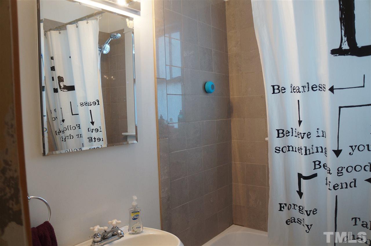 606 Sasser Street Raleigh, NC 27604 - Photo 9 of 22 a bathroom with a shower and a sink