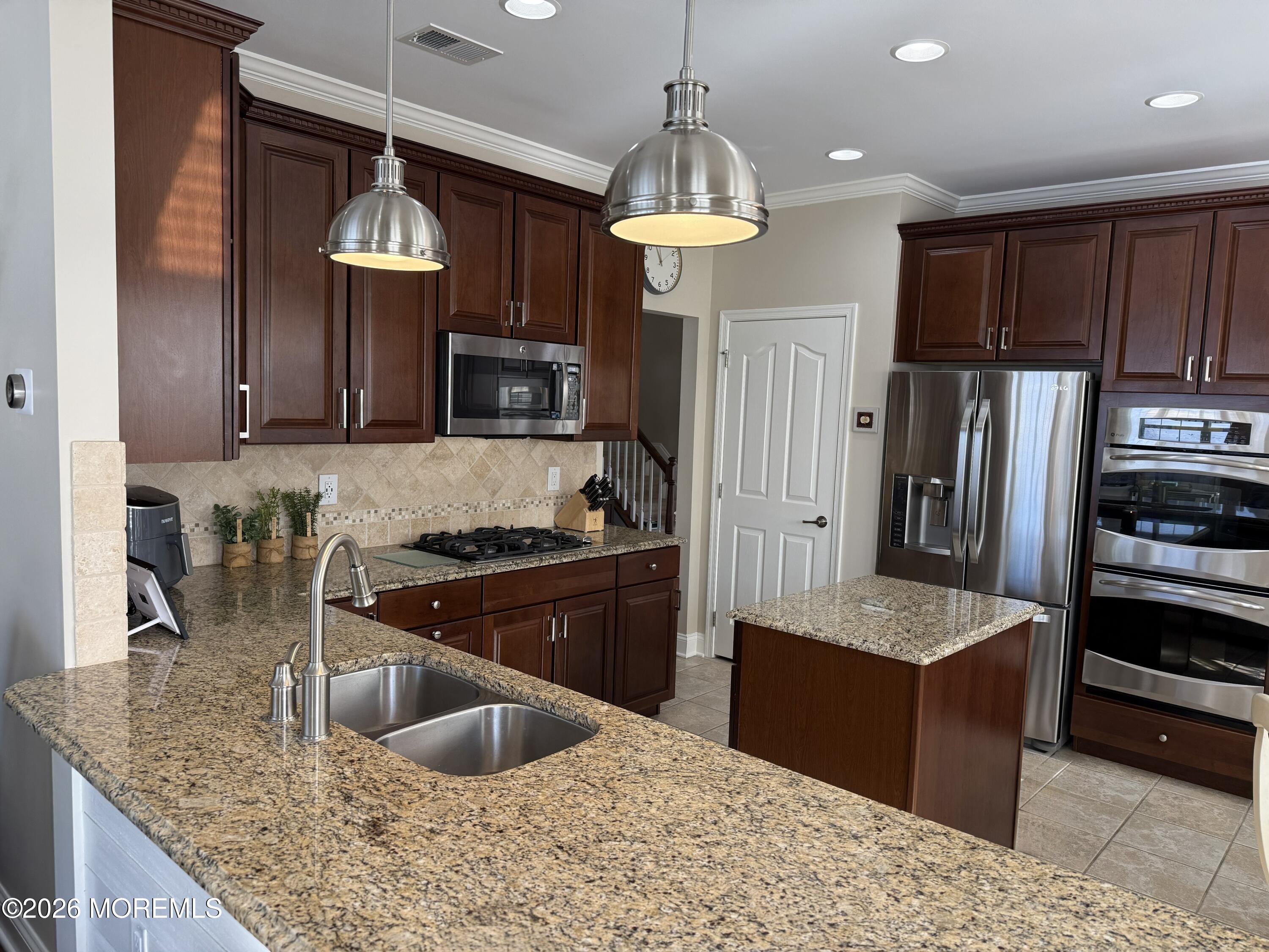 8 Fairhaven Way Waretown, NJ 08758 - Photo 30 of 68 a kitchen with stainless steel appliances granite countertop a sink refrigerator and microwave