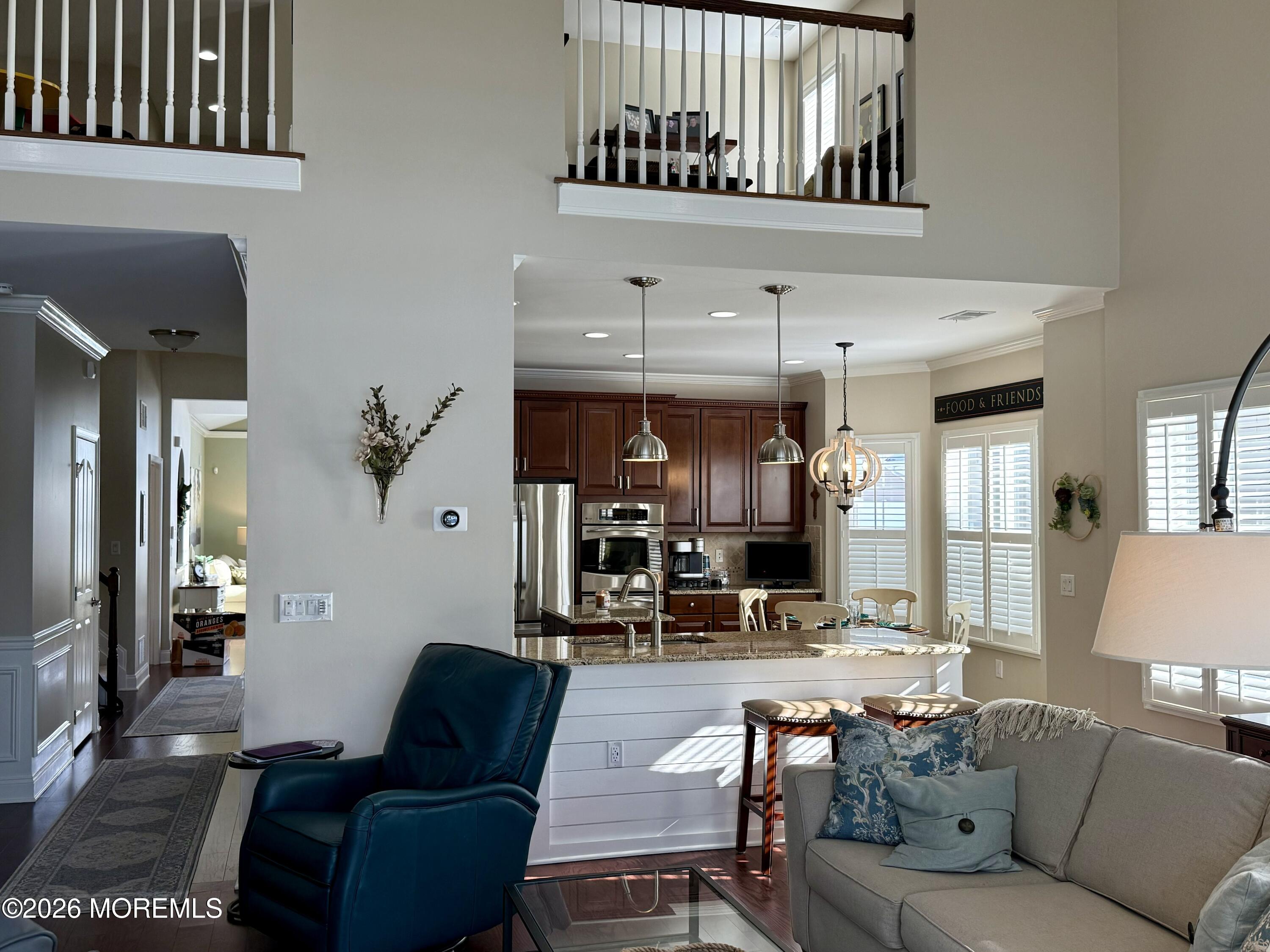 8 Fairhaven Way Waretown, NJ 08758 - Photo 31 of 68 a living room with furniture and a chandelier