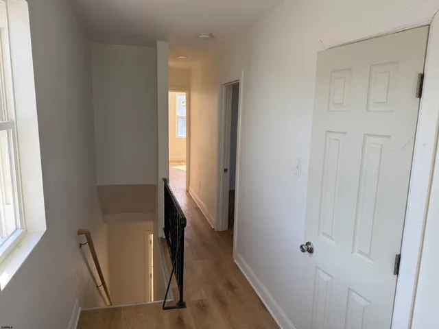 a view of an entryway with wooden floor