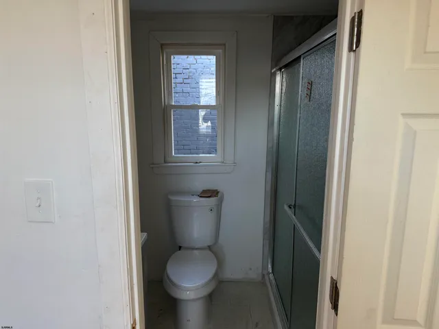 a white toilet sitting next to a bathroom sink