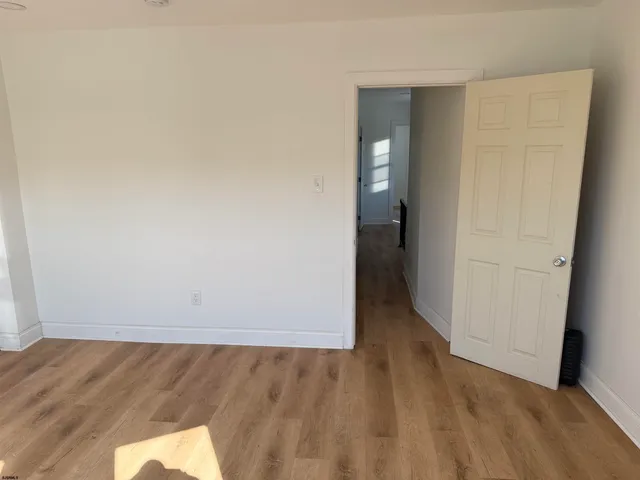 an empty room with wooden floor and closet
