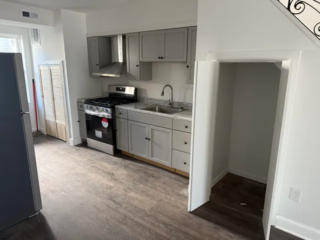 a kitchen with stainless steel appliances granite countertop a refrigerator and a sink