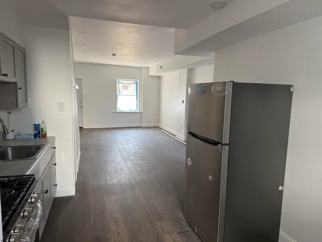 a kitchen with a refrigerator and a sink