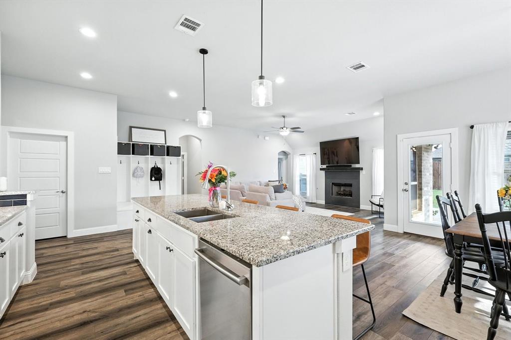 705 Chaparral Road Sanger, TX 76266 - Photo 16 of 38 a kitchen with stainless steel appliances granite countertop a sink stove and wooden floor