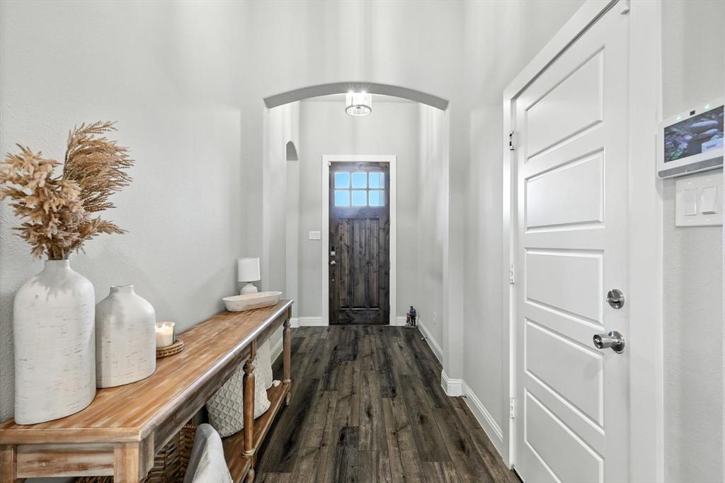 705 Chaparral Road Sanger, TX 76266 - Photo 2 of 38 a view of a hallway with wooden floor and staircase