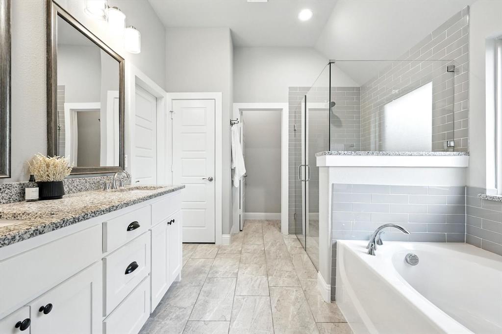 705 Chaparral Road Sanger, TX 76266 - Photo 22 of 38 a bathroom with a granite countertop tub sink shower and mirror
