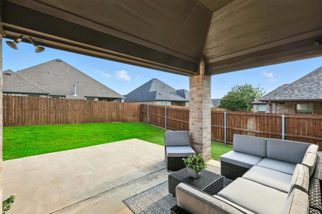 705 Chaparral Road Sanger, TX 76266 - Photo 28 of 38 a view of backyard with seating area and green space