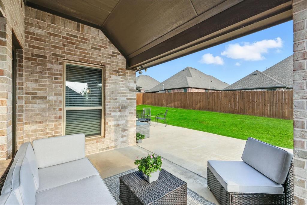 705 Chaparral Road Sanger, TX 76266 - Photo 29 of 38 a view of a patio with a table and chairs