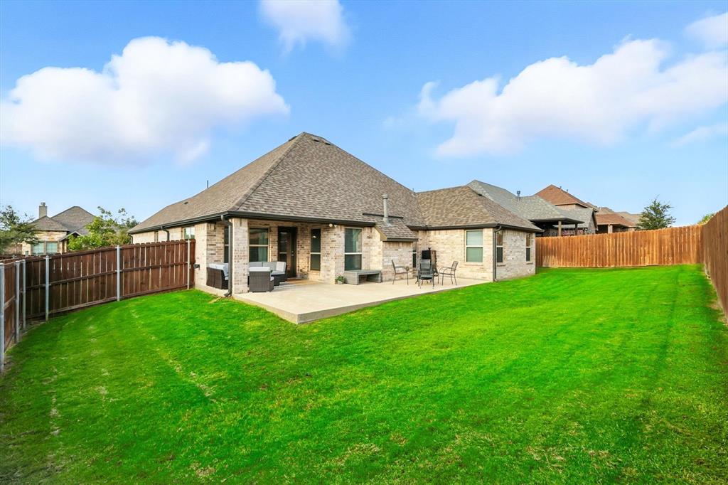 705 Chaparral Road Sanger, TX 76266 - Photo 31 of 38 a view of a house with a yard and sitting area