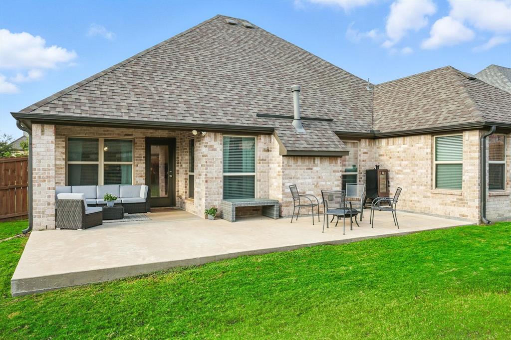 705 Chaparral Road Sanger, TX 76266 - Photo 32 of 38 a front view of a house with patio and garden