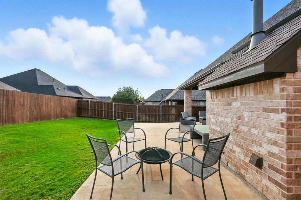 705 Chaparral Road Sanger, TX 76266 - Photo 33 of 38 a backyard of a house with table and chairs