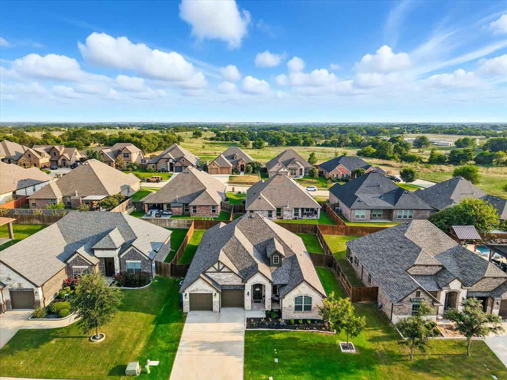 705 Chaparral Road Sanger, TX 76266 - Photo 35 of 38 an aerial view of residential houses with outdoor space and ocean view