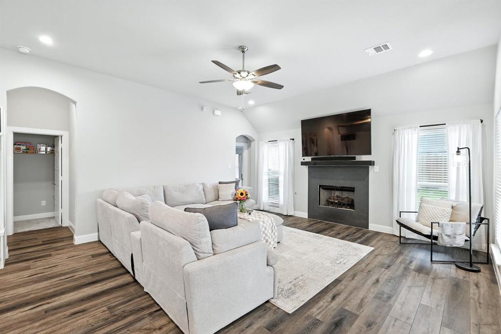 705 Chaparral Road Sanger, TX 76266 - Photo 6 of 38 a living room with furniture fireplace and a flat screen tv
