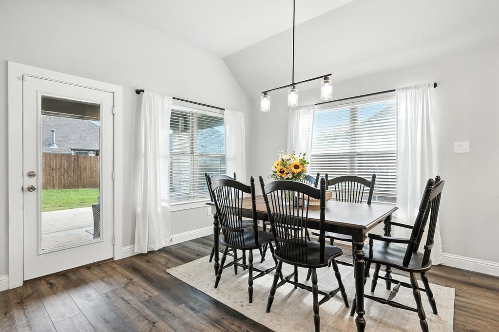 705 Chaparral Road Sanger, TX 76266 - Photo 9 of 38 a view of a dining room with furniture window and wooden floor