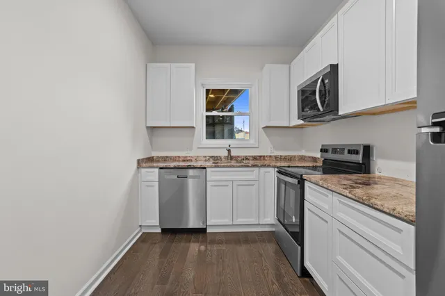 a kitchen with stainless steel appliances granite countertop a stove and a sink