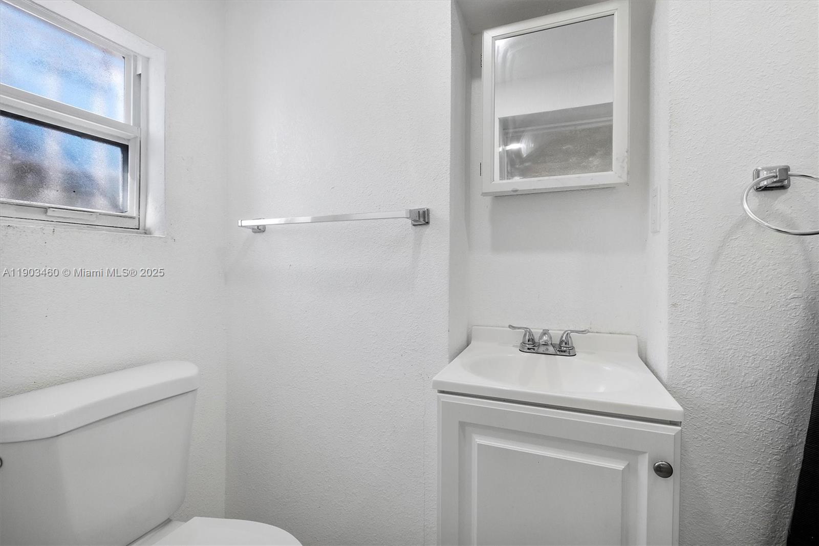 7231 Southwest 6th Street Miami, FL 33144 - Photo 11 of 34 a bathroom with a sink a toilet and a mirror