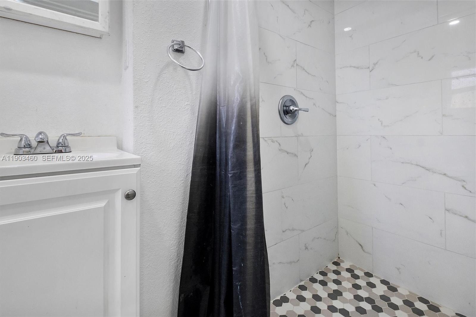 7231 Southwest 6th Street Miami, FL 33144 - Photo 12 of 34 a bathroom with a sink a toilet a shower and a mirror