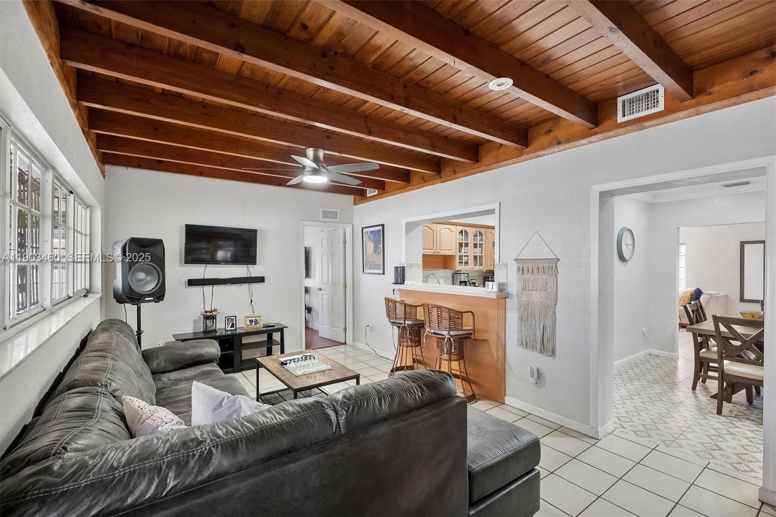 7231 Southwest 6th Street Miami, FL 33144 - Photo 14 of 34 a living room with furniture and a flat screen tv