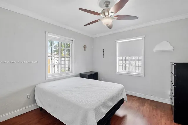 a bedroom with a large bed window and a chandelier