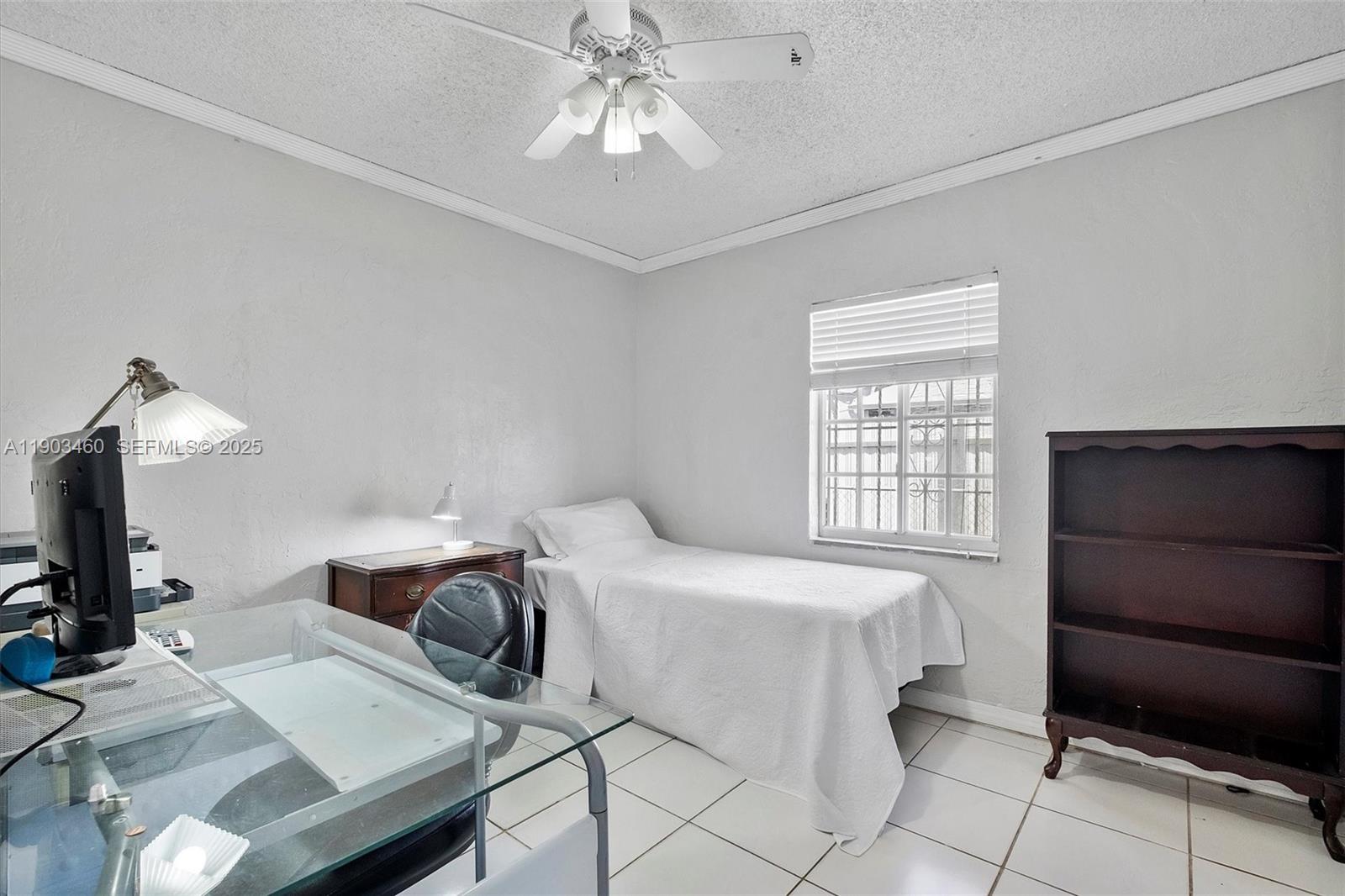 7231 Southwest 6th Street Miami, FL 33144 - Photo 18 of 34 a bedroom with a bed and a chandelier
