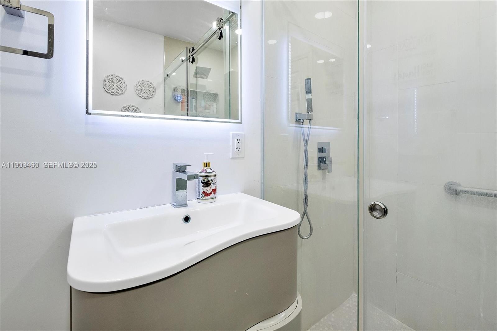 7231 Southwest 6th Street Miami, FL 33144 - Photo 20 of 34 a bathroom with a sink a mirror and a shower