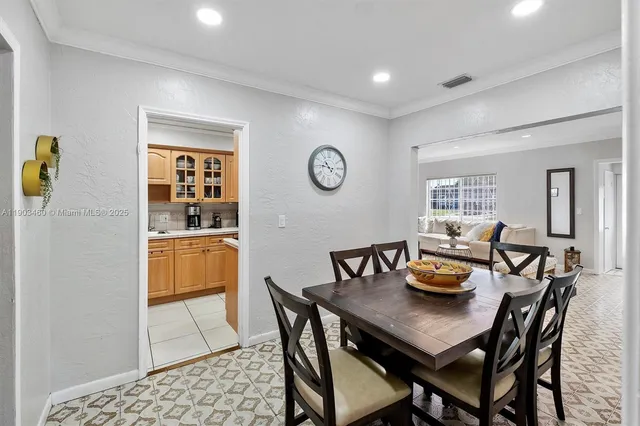 a view of a dining room with furniture and window