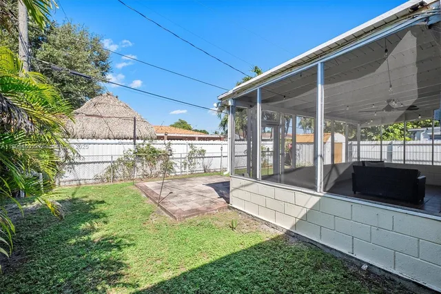 a view of an house with backyard space and balcony