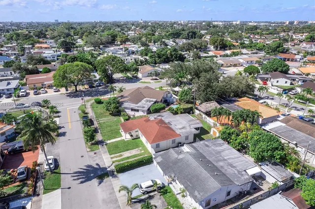 an aerial view of residential houses with outdoor space