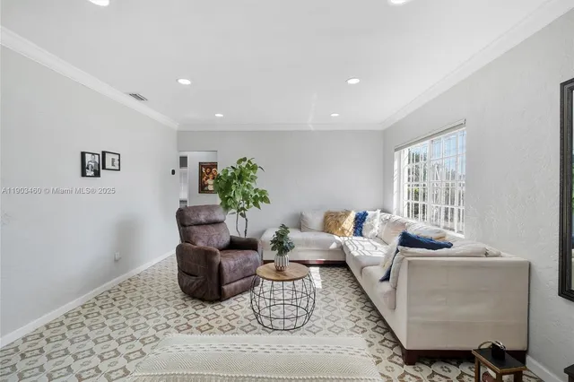 a living room with furniture rug and window