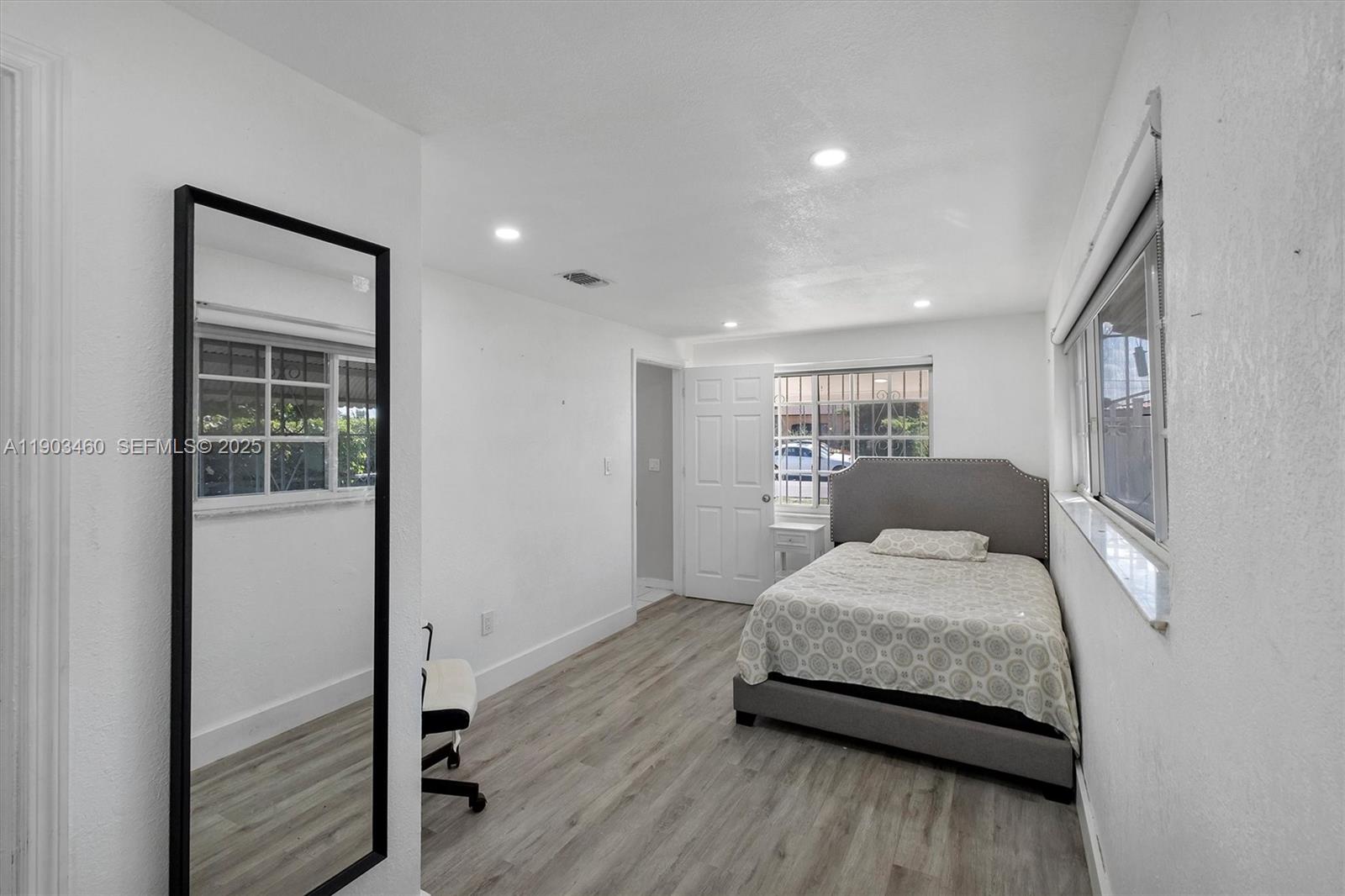 7231 Southwest 6th Street Miami, FL 33144 - Photo 10 of 34 a bedroom with a bed and a view of kitchen