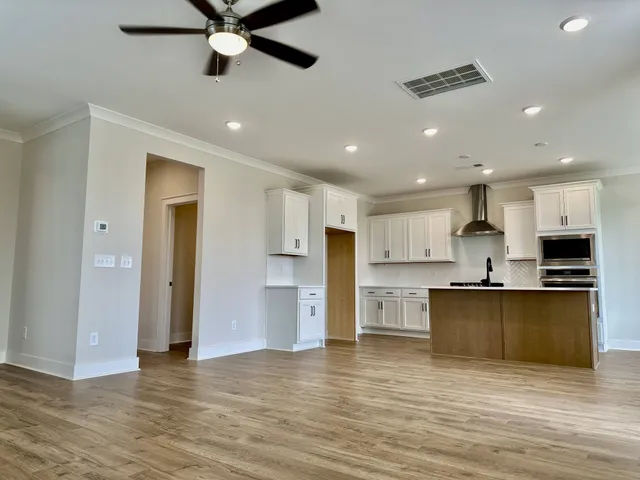 a view of kitchen with wooden floor and a window
