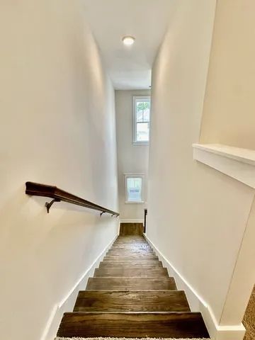a view of a room with wooden floor and staircase