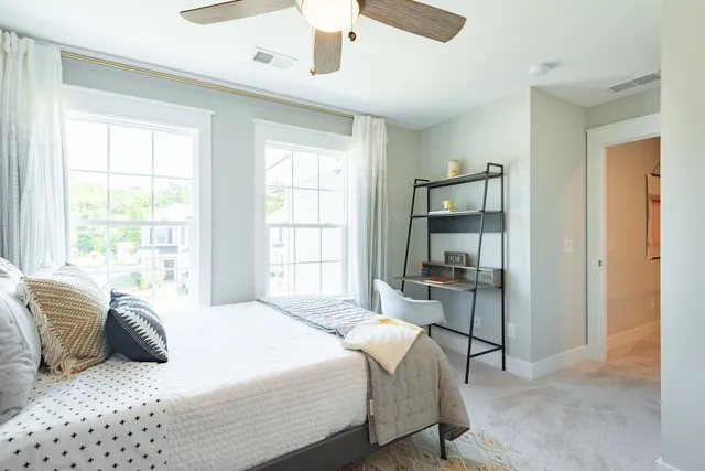 a bedroom with a bed and a large window